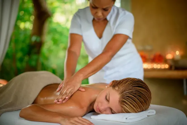 Woman relaxing as she receives a massage in Cala Luna hotel