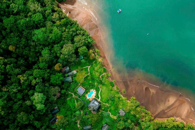Playa Cativo Lodge from the air, showcasing rainforests and deep ocean blues