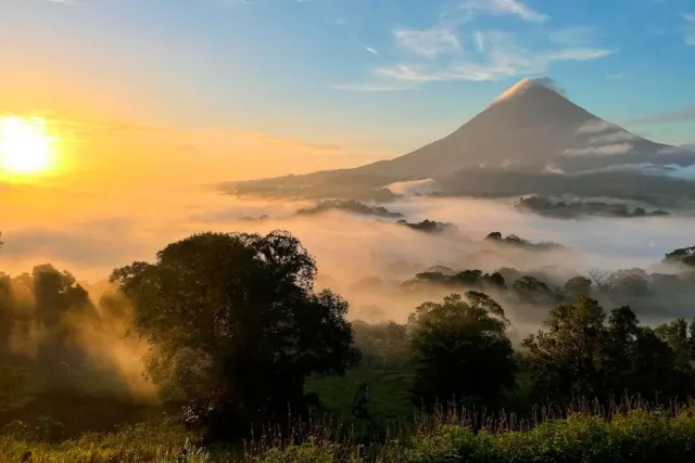Sunset shadowing over the foggy Arenal Volcano in Costa Rica
