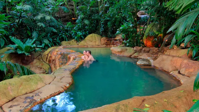 Couple sharing a quiet moment in the hot springs pool surrounded by nature
